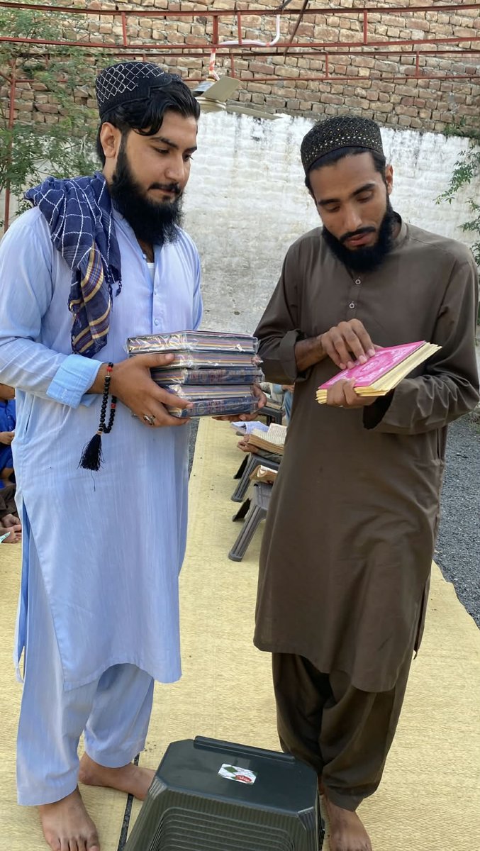 IRT Foundation team delivering Quran Pak and Noorani Qaida to a madrasah