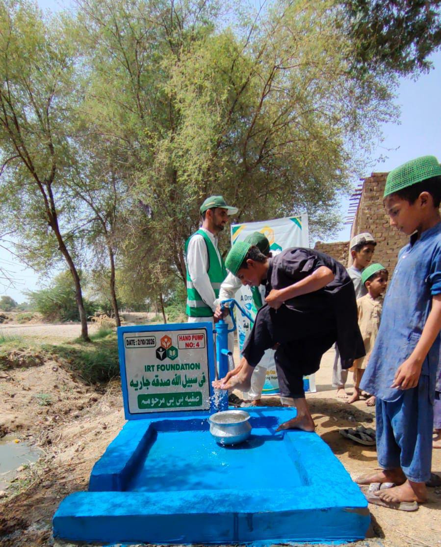 Clean water for a child at IRT Hand Pump No. 4